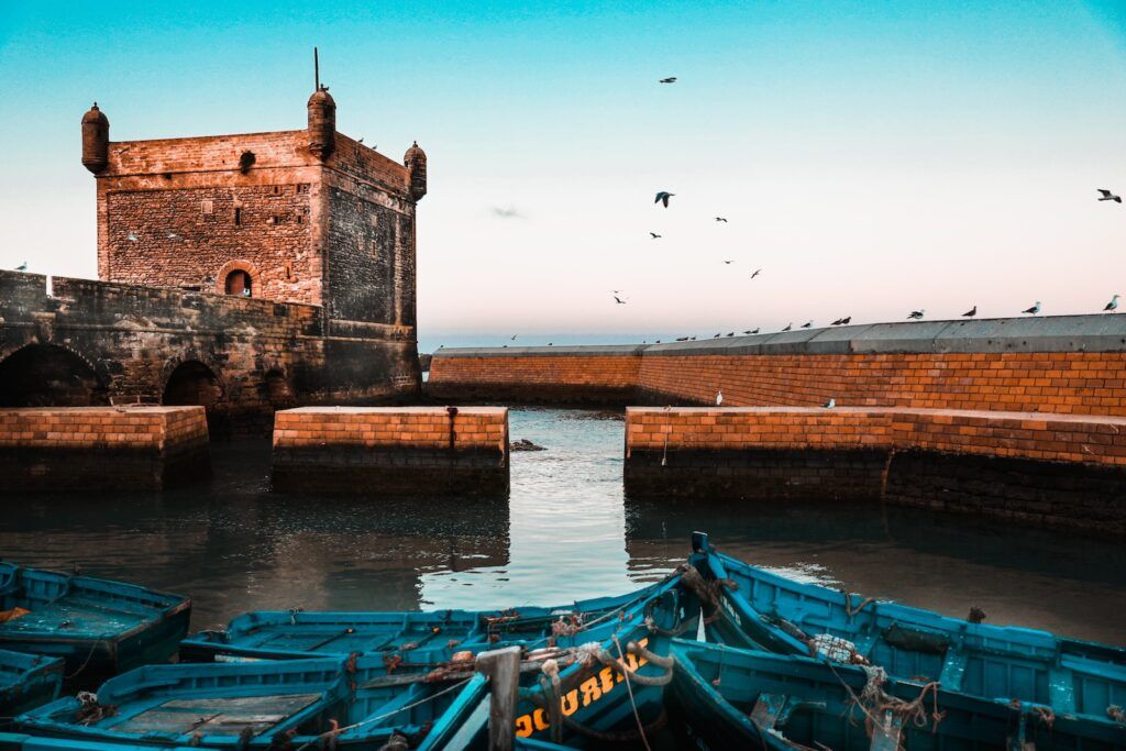 essaouira visit morocco brown brick building near body of water during daytime